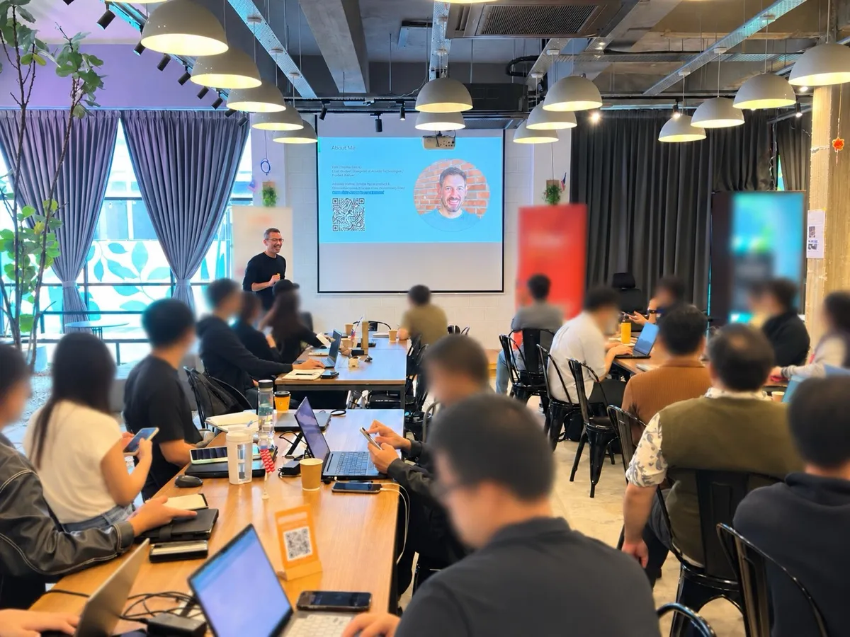 Tom presenting to a full room of founders with laptops